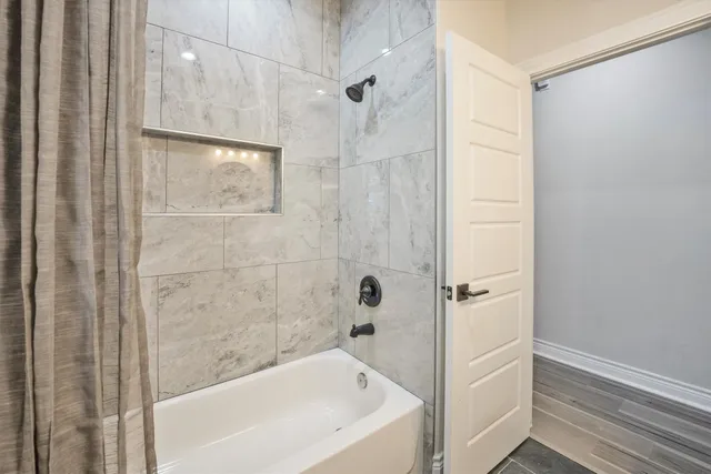 a bathroom with a bathtub and shower