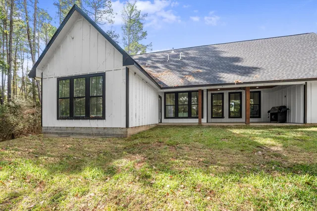 a view of a room with a ceiling fan and windows