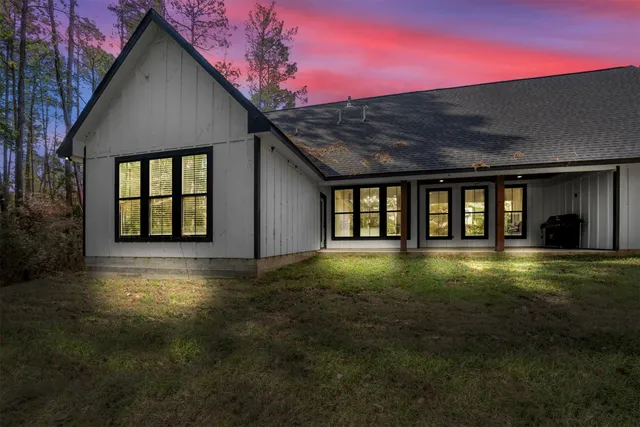 a front view of a house with a yard and balcony