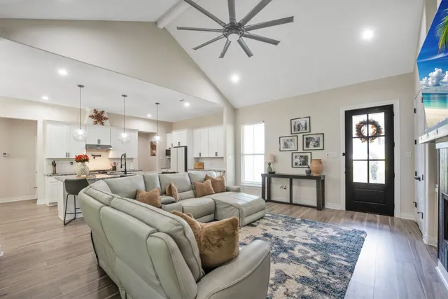 a living room with furniture and a wooden floor