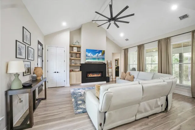 a bedroom with a bed wooden floor and furniture