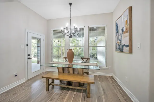 a view of a livingroom with furniture wooden floor and chandelier