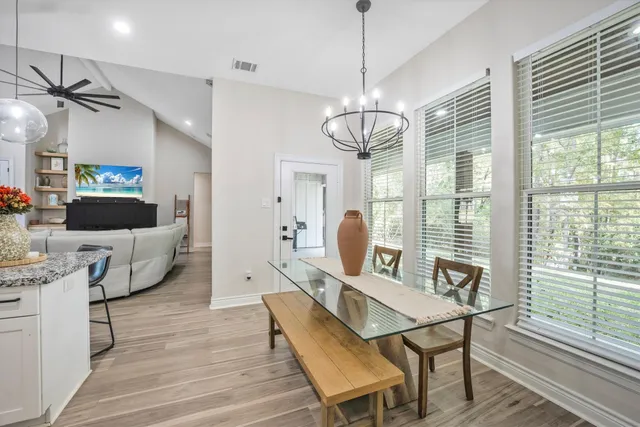 a view of a dining room with furniture wooden floor and chandelier