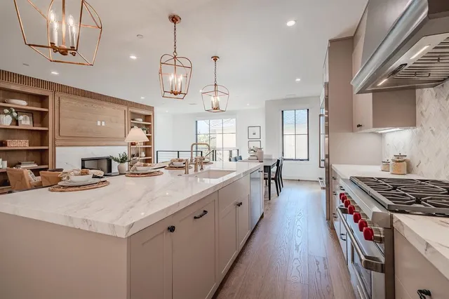 a kitchen with white cabinets appliances and a counter
