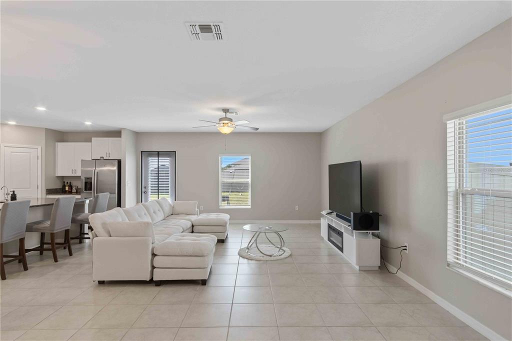 9440 Lemon Drop Loop Sun City Center, FL 33573 - Photo 21 of 55 a living room with furniture a flat screen tv and a window