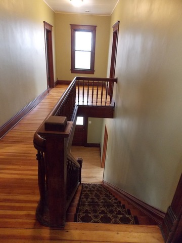 2265 North 3806th Road Serena, IL 60549 - Photo 11 of 19 a view of a hallway with wooden floor and staircase