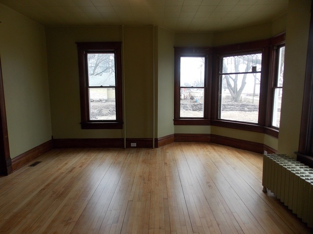 2265 North 3806th Road Serena, IL 60549 - Photo 4 of 19 an empty room with wooden floor and windows