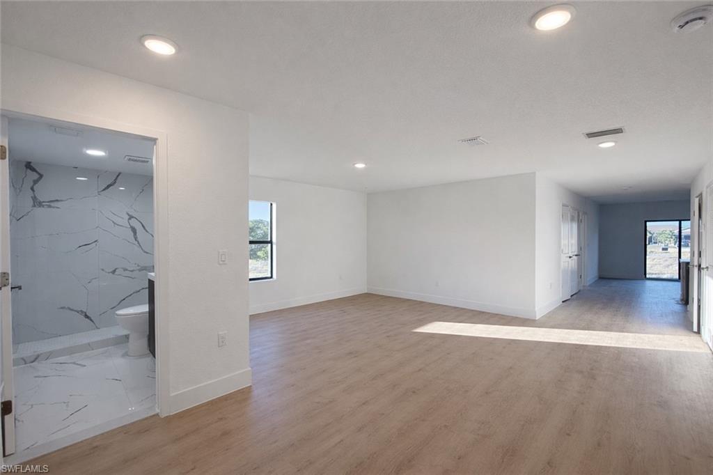 2812 23rd Street Southwest Lehigh Acres, FL 33976 - Photo 9 of 17 an empty room with windows and entrance