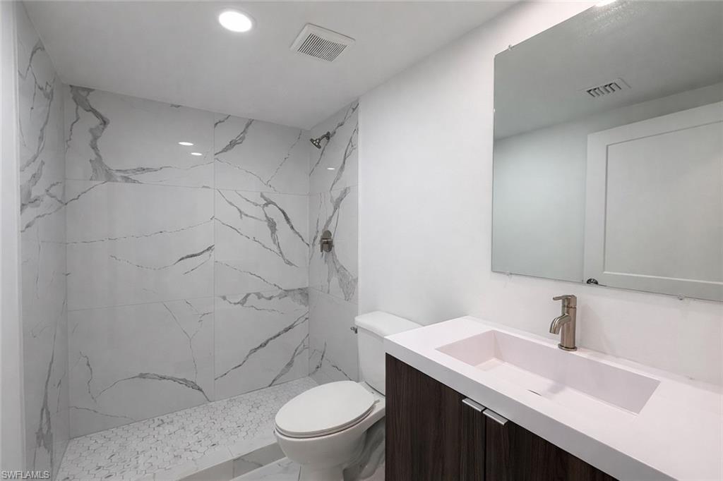 2812 23rd Street Southwest Lehigh Acres, FL 33976 - Photo 10 of 17 a bathroom with a sink a toilet and shower
