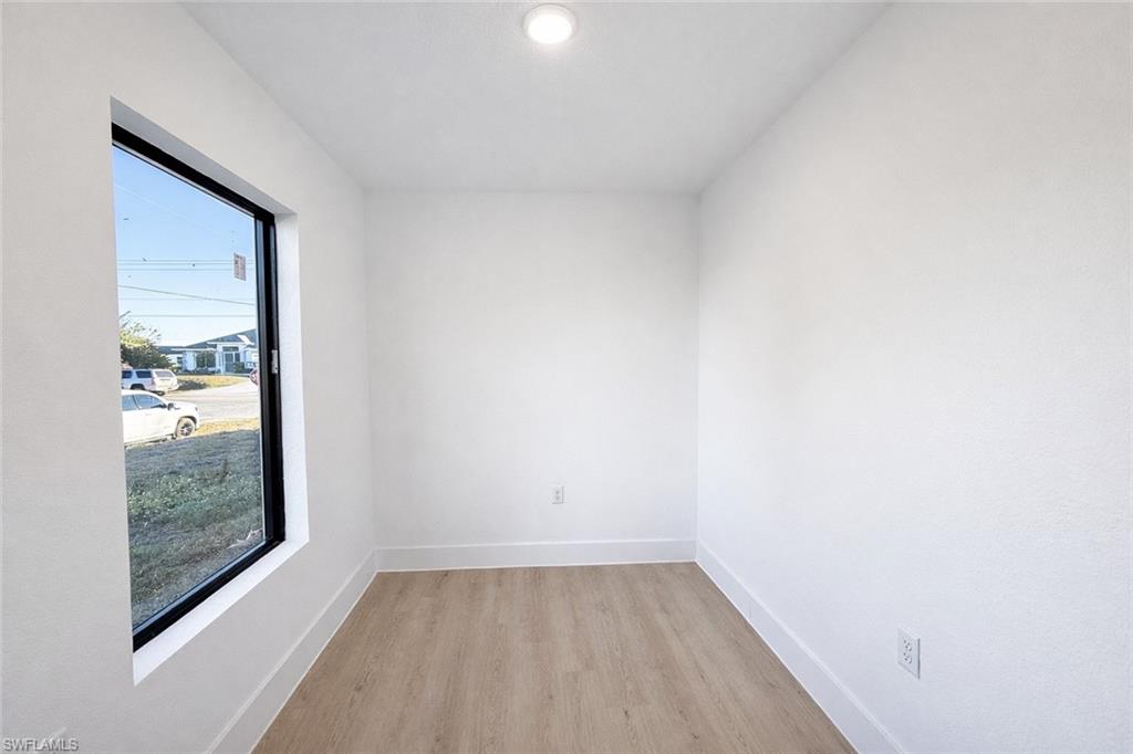 2812 23rd Street Southwest Lehigh Acres, FL 33976 - Photo 14 of 17 a view of a small space with wooden floor and a window