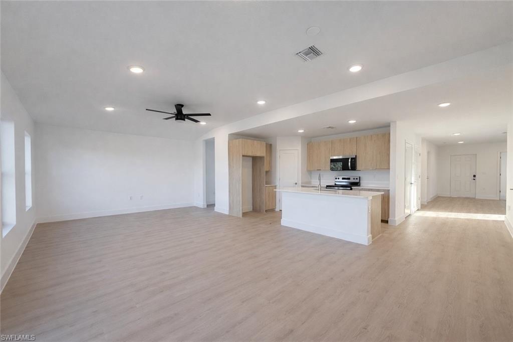 2812 23rd Street Southwest Lehigh Acres, FL 33976 - Photo 15 of 17 a view of kitchen with kitchen island white cabinets and refrigerator