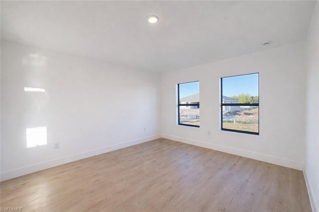 2812 23rd Street Southwest Lehigh Acres, FL 33976 - Photo 5 of 17 an empty room with windows and entrance