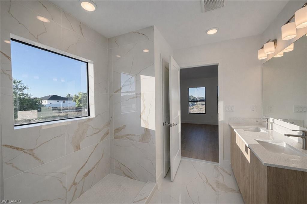 2812 23rd Street Southwest Lehigh Acres, FL 33976 - Photo 6 of 17 a bathroom with a bathtub and a window