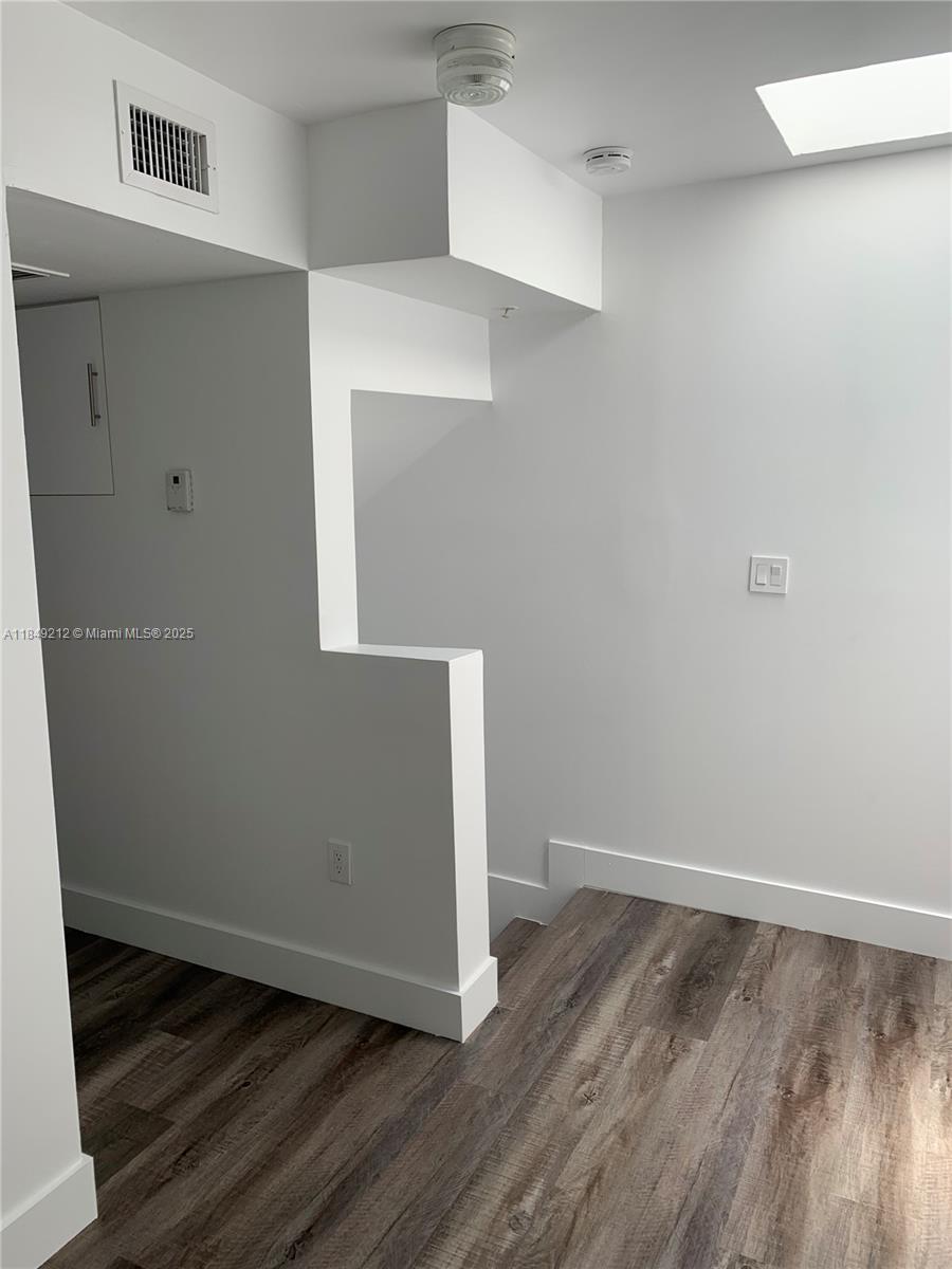 450 Southwest 3rd Street, Unit 10 Miami, FL 33130 - Photo 13 of 13 a view of an empty room with wooden floor and closet
