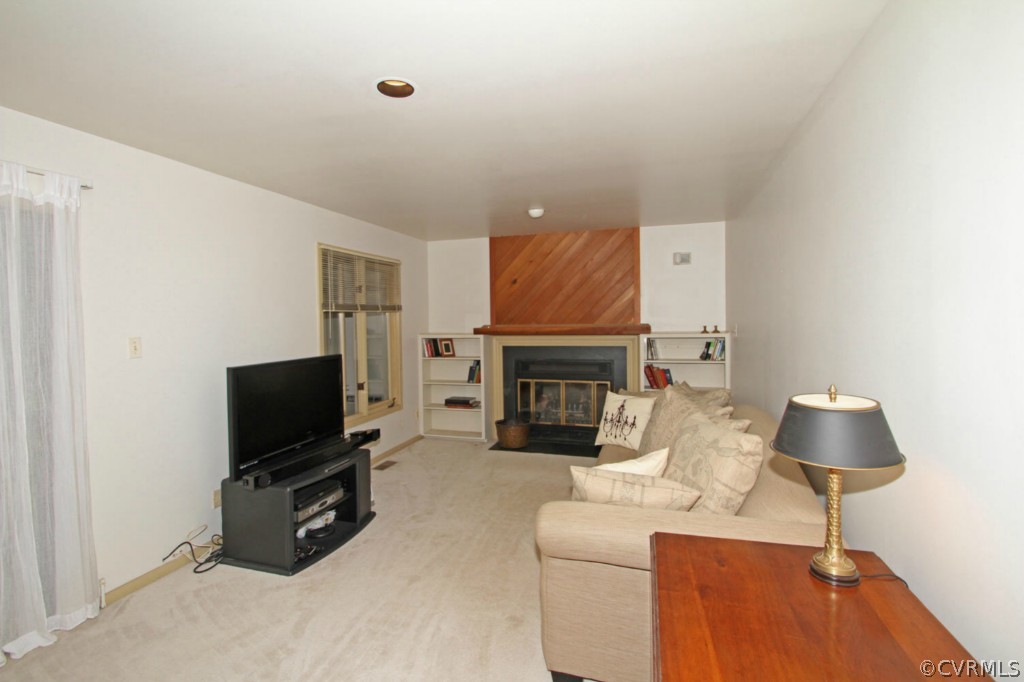 12211 Spring Run Road Chesterfield, VA 23832 - Photo 8 of 24 a living room with furniture a flat screen tv and a fireplace