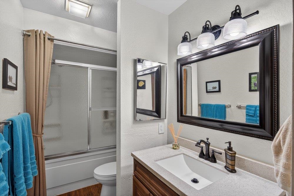 112 Poplar Valley Road Blairsden, CA 96103 - Photo 14 of 28 a bathroom with a sink a toilet a mirror and shower