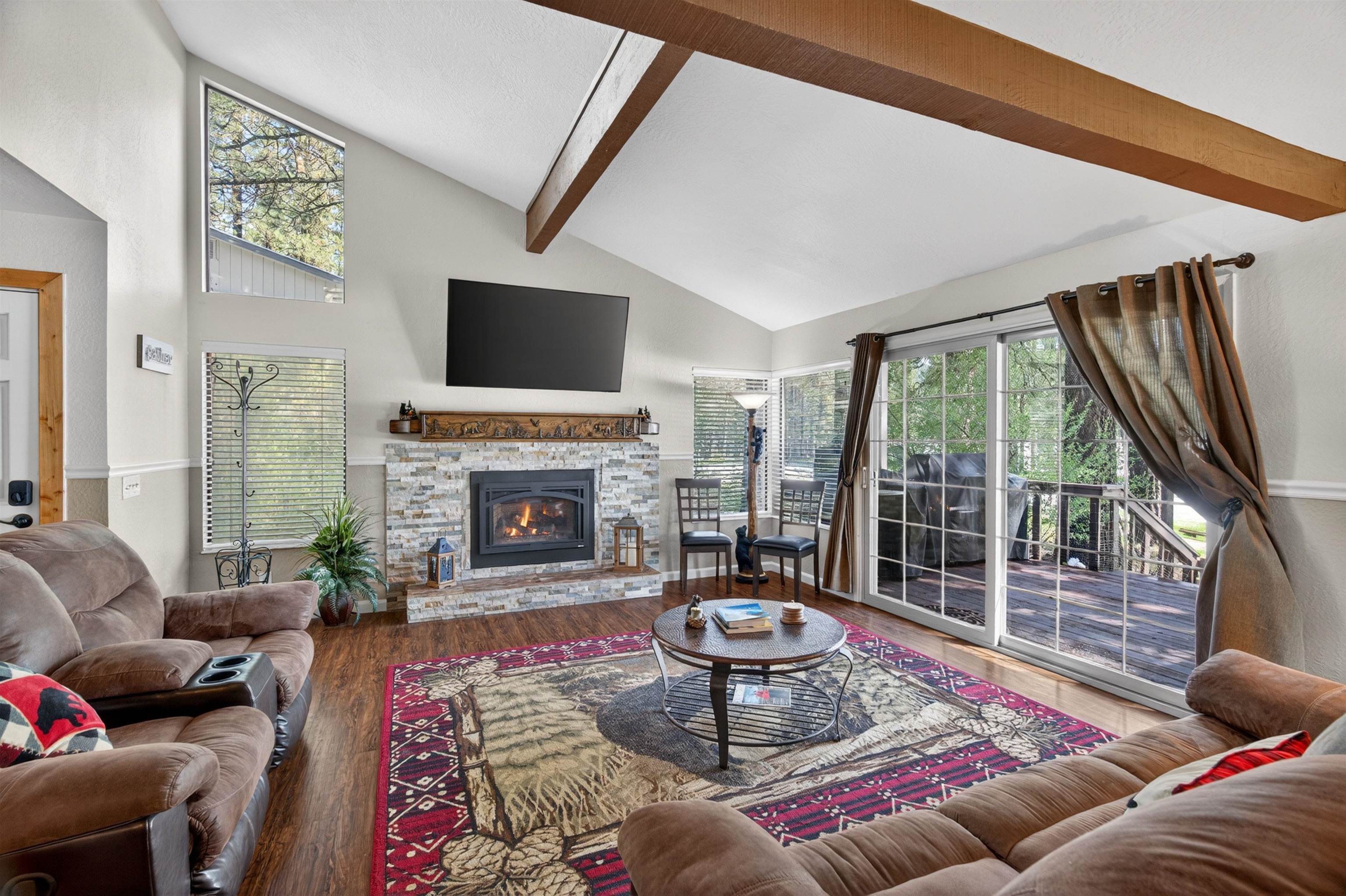 112 Poplar Valley Road Blairsden, CA 96103 - Photo 3 of 28 a living room with furniture a fireplace and a floor to ceiling window