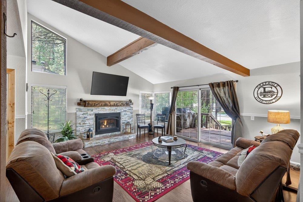 112 Poplar Valley Road Blairsden, CA 96103 - Photo 6 of 28 a living room with furniture a fireplace and a floor to ceiling window