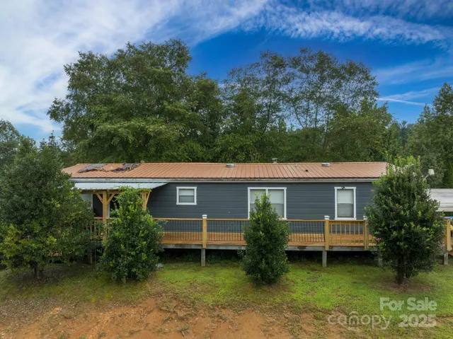 a water view of a lake with large trees