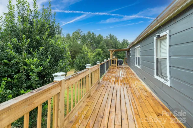 a balcony with wooden floor and furniture