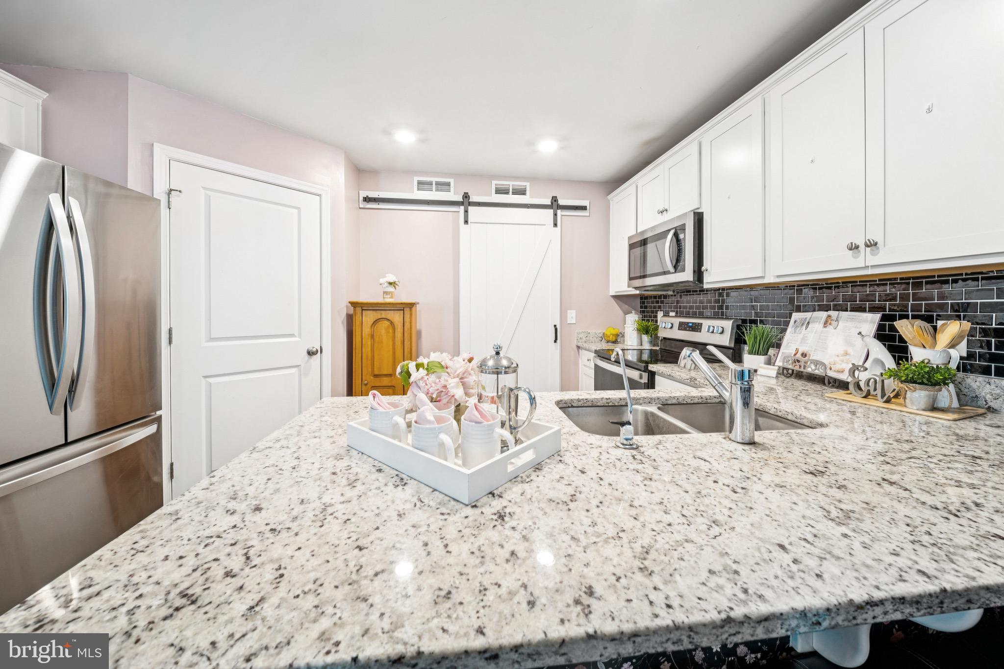 17912 Meriwether Lewis Street Ruther Glen, VA 22546 - Photo 14 of 44 a kitchen with stainless steel appliances granite countertop a refrigerator sink and stove