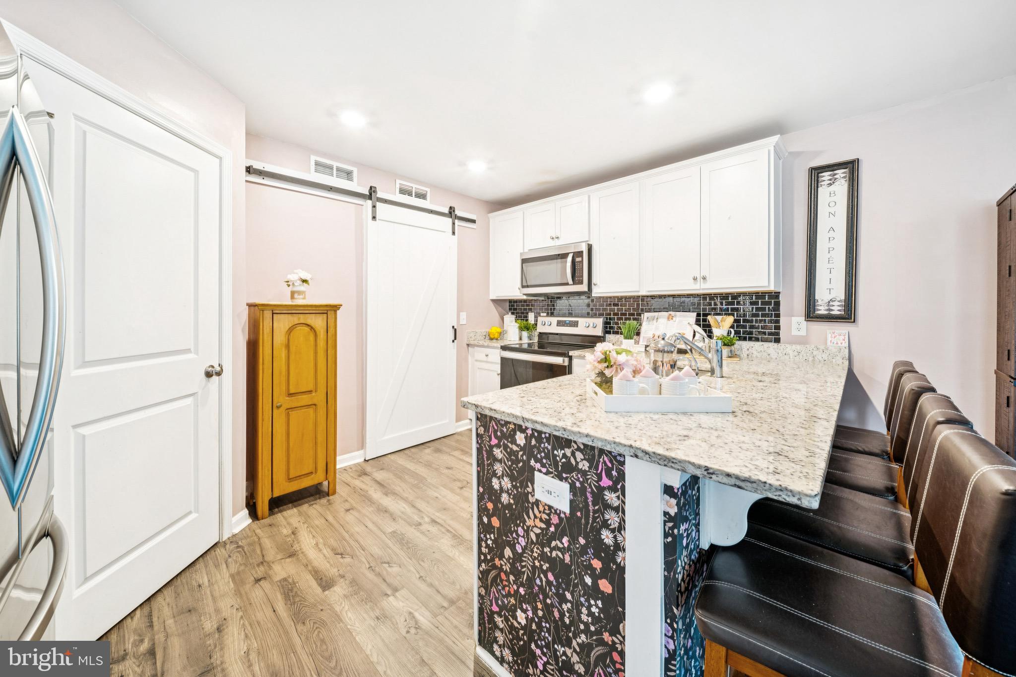 17912 Meriwether Lewis Street Ruther Glen, VA 22546 - Photo 15 of 44 a kitchen with kitchen island a appliances dining table and chairs