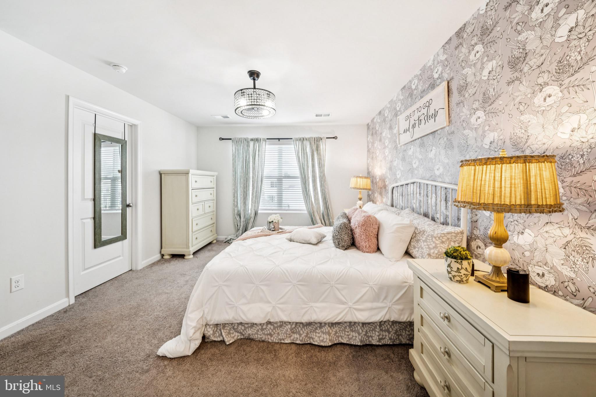 17912 Meriwether Lewis Street Ruther Glen, VA 22546 - Photo 20 of 44 a bedroom with a bed and a chandelier