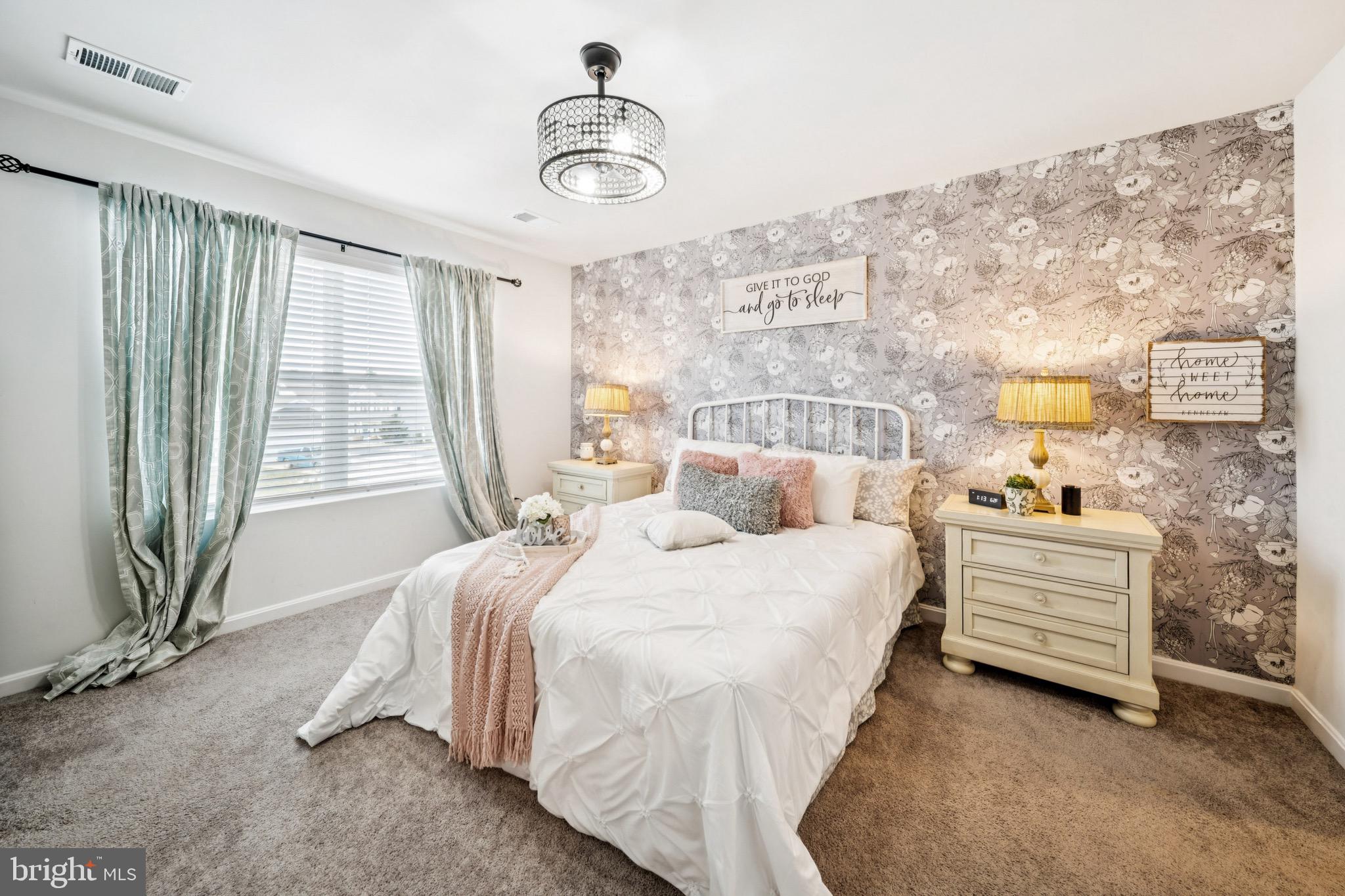 17912 Meriwether Lewis Street Ruther Glen, VA 22546 - Photo 21 of 44 a bedroom with a bed and a chandelier