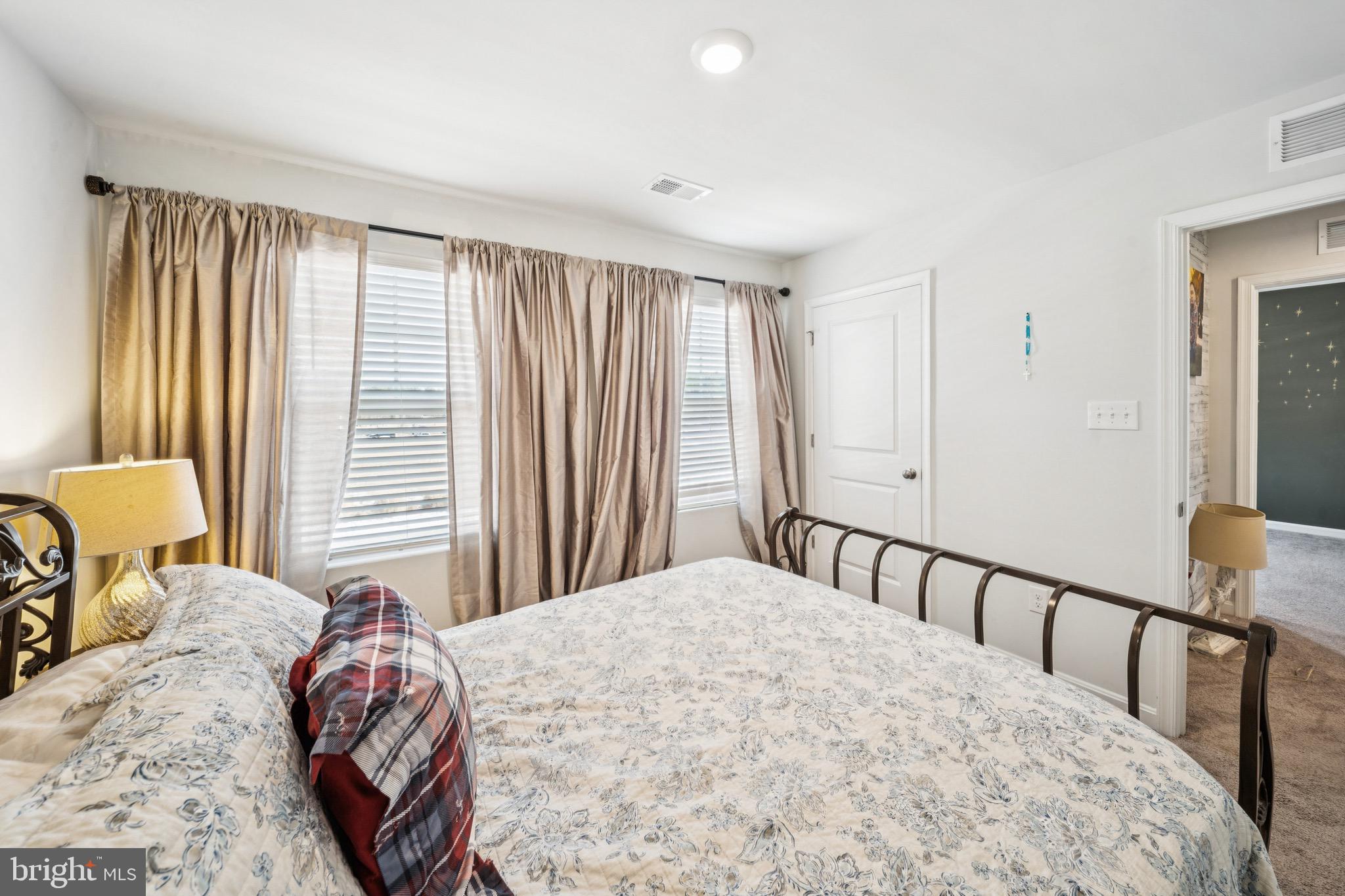 17912 Meriwether Lewis Street Ruther Glen, VA 22546 - Photo 27 of 44 a bedroom with a bed and a large window