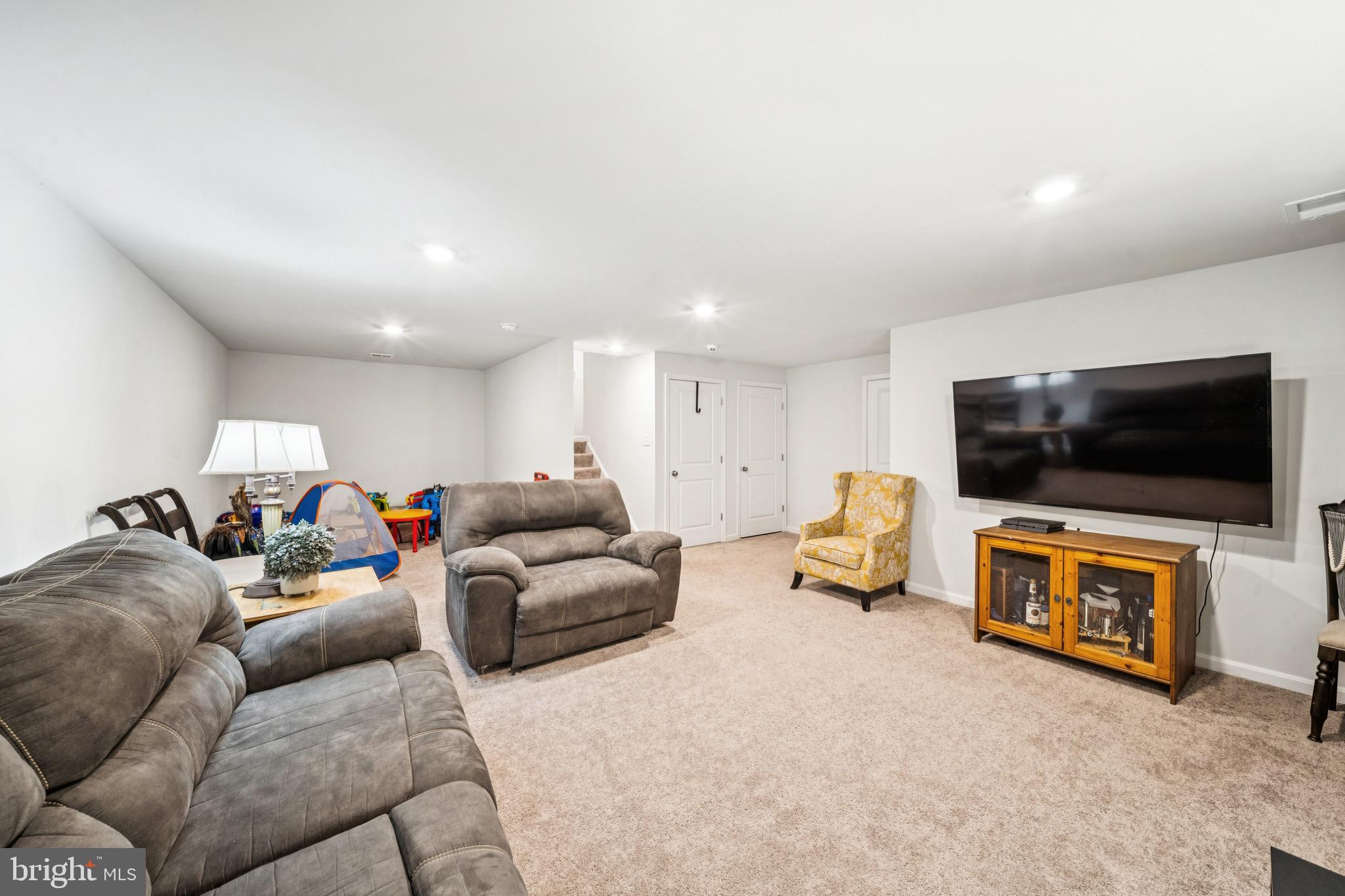 17912 Meriwether Lewis Street Ruther Glen, VA 22546 - Photo 37 of 44 a living room with furniture and a flat screen tv