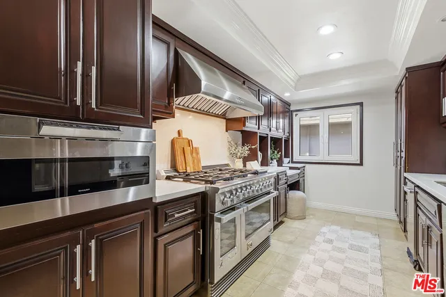 a kitchen with stainless steel appliances granite countertop a stove and a sink