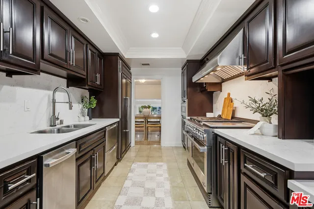 a kitchen with a stove sink and cabinets