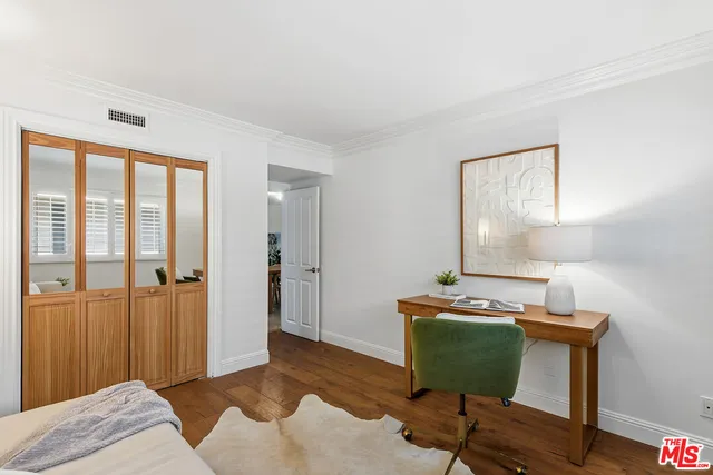 a bedroom with a bed and a chair