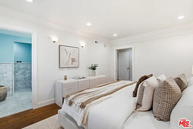 a bedroom with a bed and a mirror