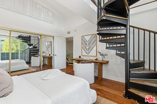 a bedroom with furniture and a window