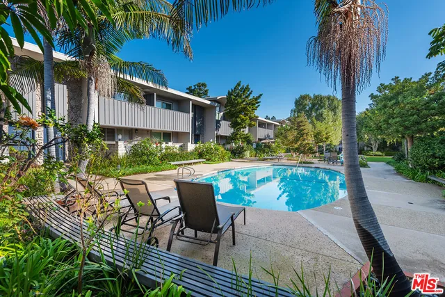 a view of a house with swimming pool and sitting area