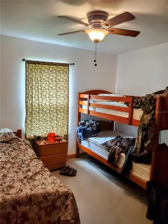 a bedroom with bed and a chandelier