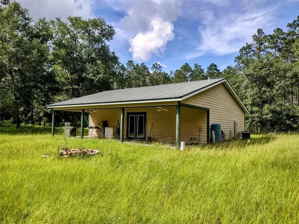 a backyard of a house with yard and barbeque oven