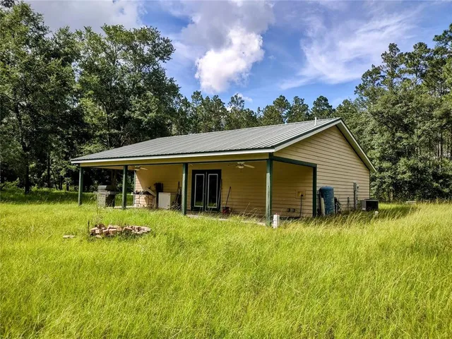 a backyard of a house with yard and barbeque oven