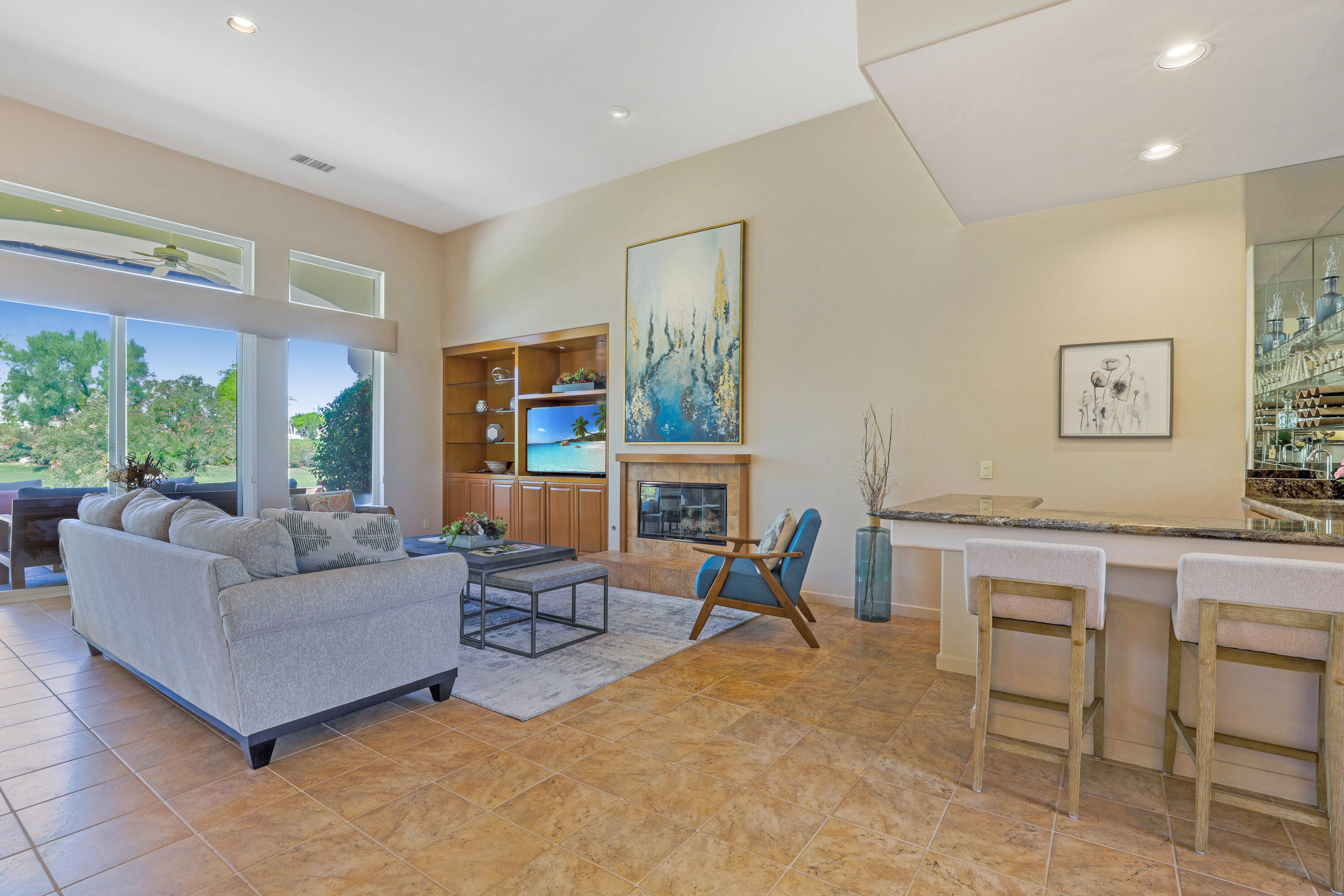 701 Indian Ridge Drive Palm Desert, CA 92211 - Photo 12 of 40 a living room with furniture a large window and dining table