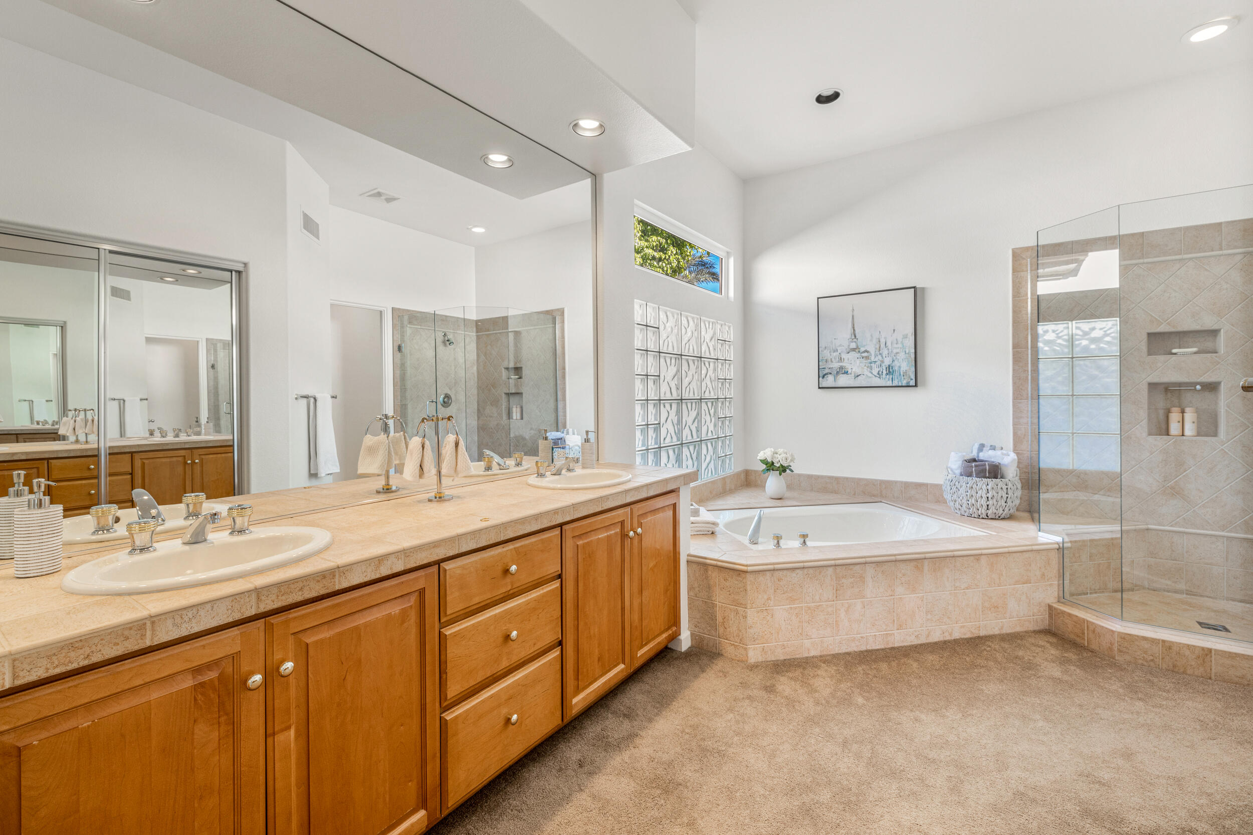 701 Indian Ridge Drive Palm Desert, CA 92211 - Photo 20 of 40 a spacious bathroom with a double vanity sink large mirror and a bathtub