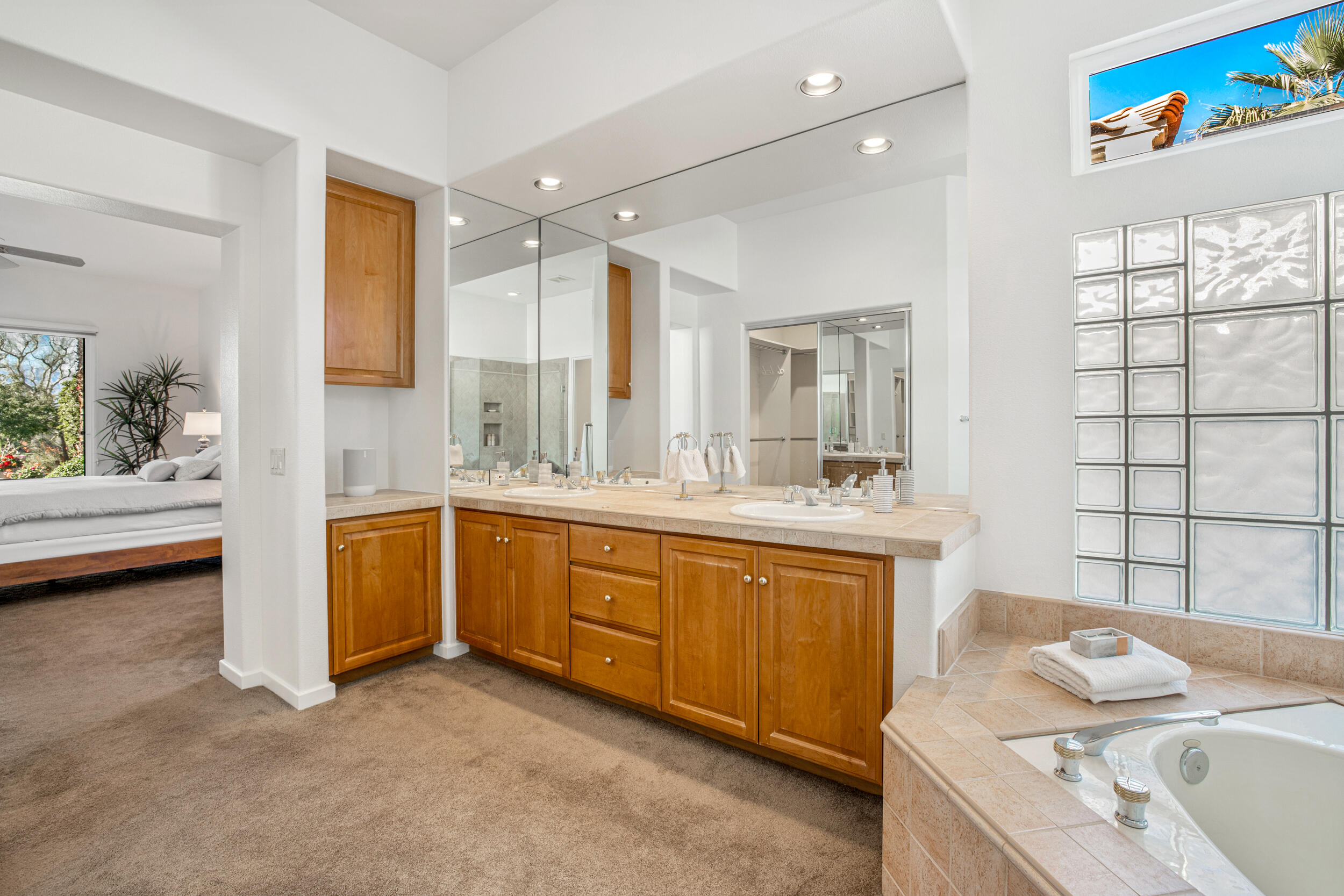701 Indian Ridge Drive Palm Desert, CA 92211 - Photo 22 of 40 a spacious bathroom with a granite countertop sink mirror and a bathtub