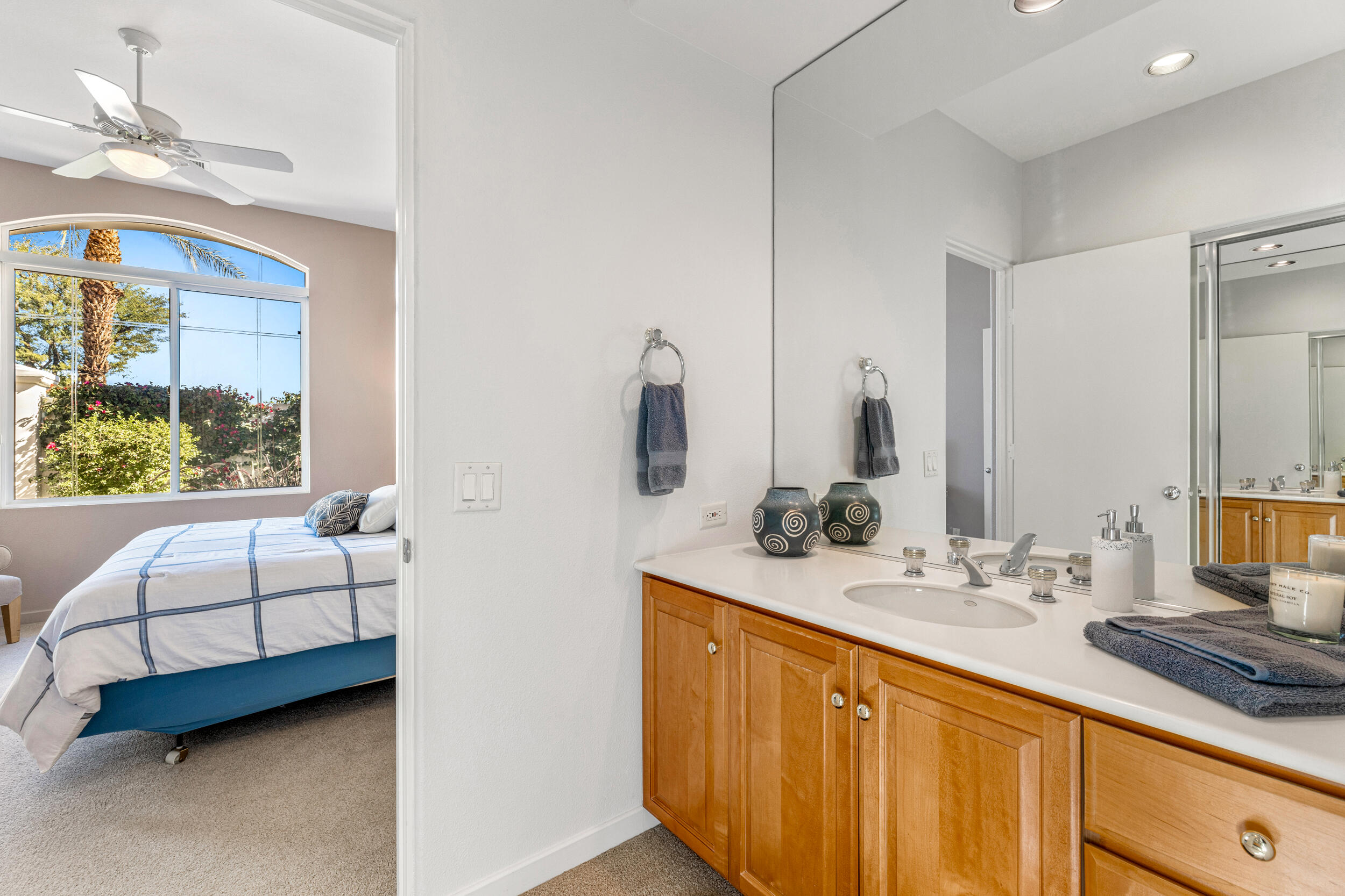 701 Indian Ridge Drive Palm Desert, CA 92211 - Photo 26 of 40 a bathroom with a double vanity sink a mirror and a bathtub