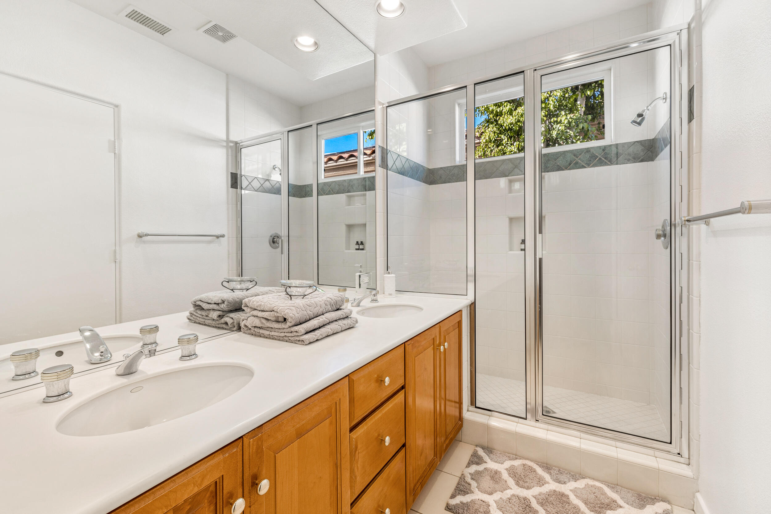 701 Indian Ridge Drive Palm Desert, CA 92211 - Photo 29 of 40 a bathroom with a double vanity sink and mirror
