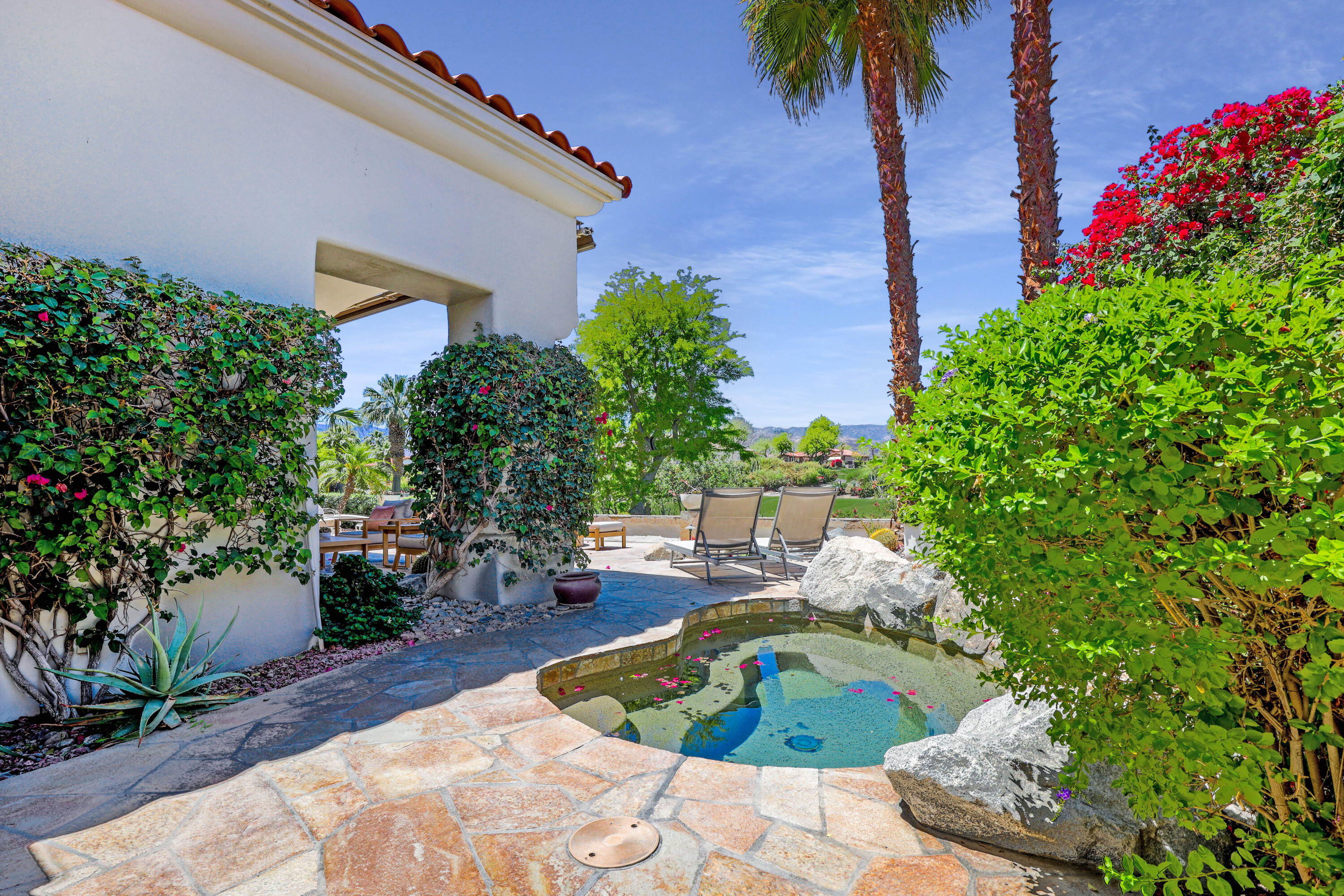 701 Indian Ridge Drive Palm Desert, CA 92211 - Photo 3 of 40 a house view with a garden space