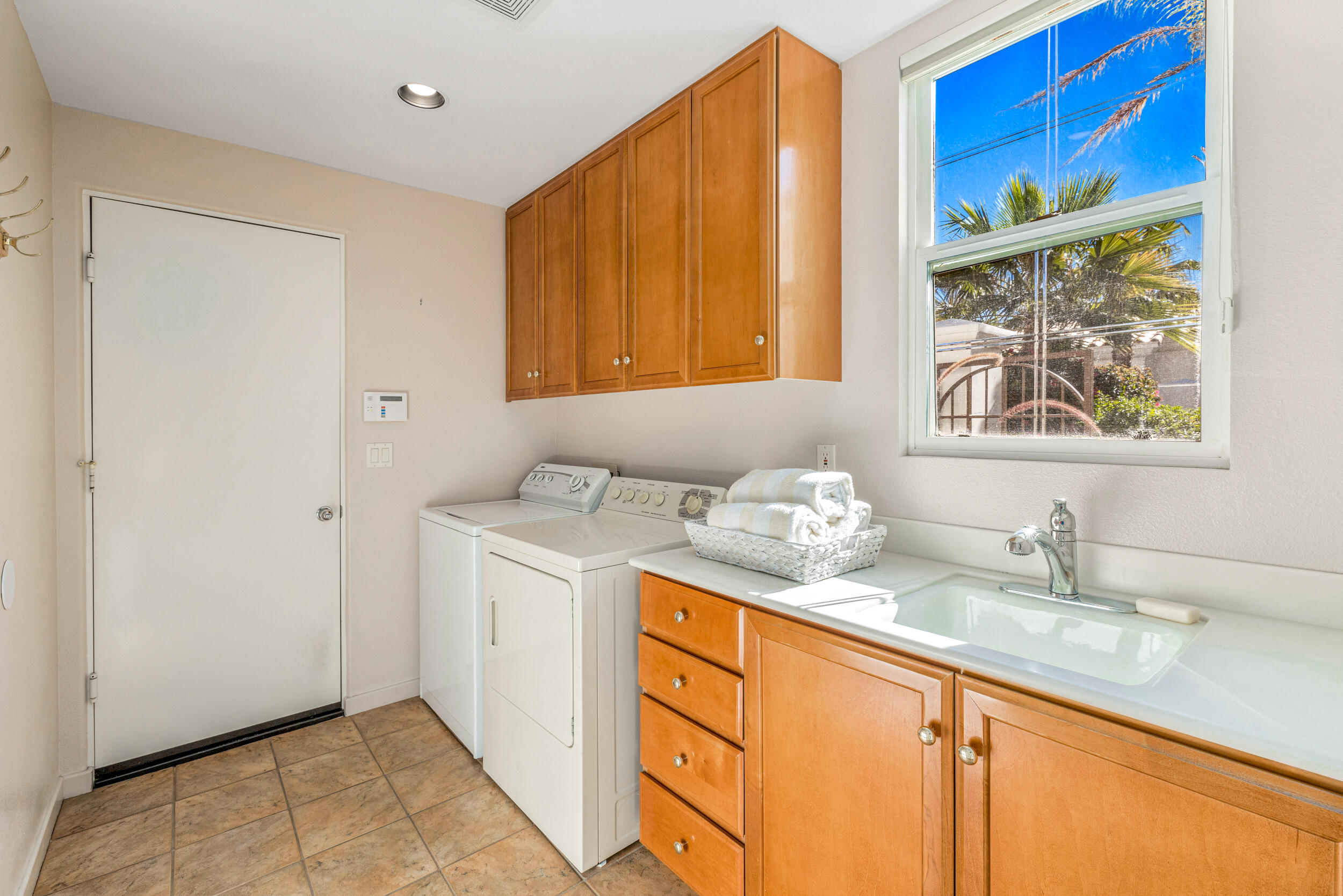 701 Indian Ridge Drive Palm Desert, CA 92211 - Photo 32 of 40 a bathroom with a granite countertop sink and a window