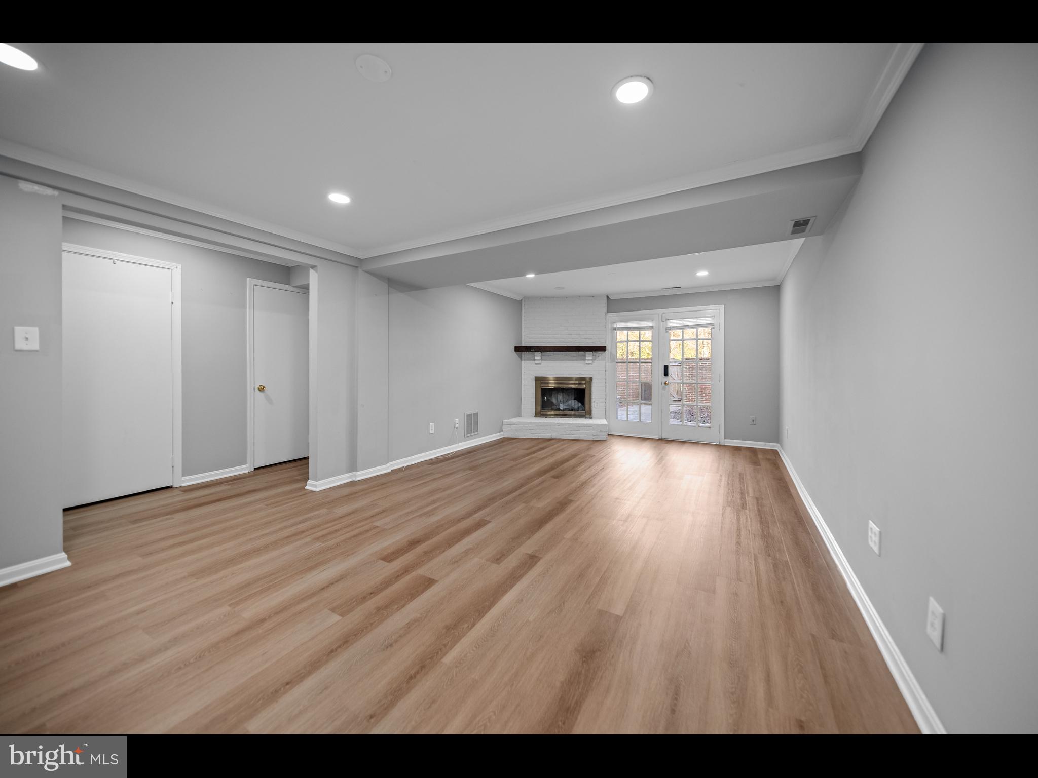 1609 Dunterry Place McLean, VA 22101 - Photo 14 of 36 a view of empty room with wooden floor and kitchen