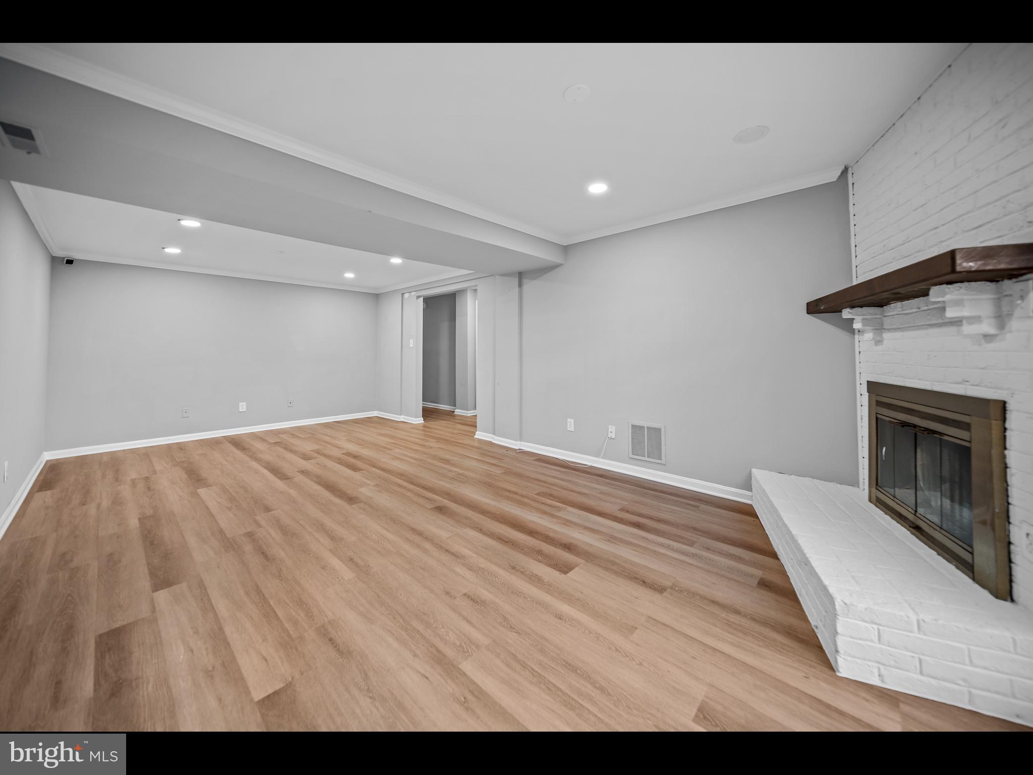 1609 Dunterry Place McLean, VA 22101 - Photo 16 of 36 a view of empty room with wooden floor and fireplace