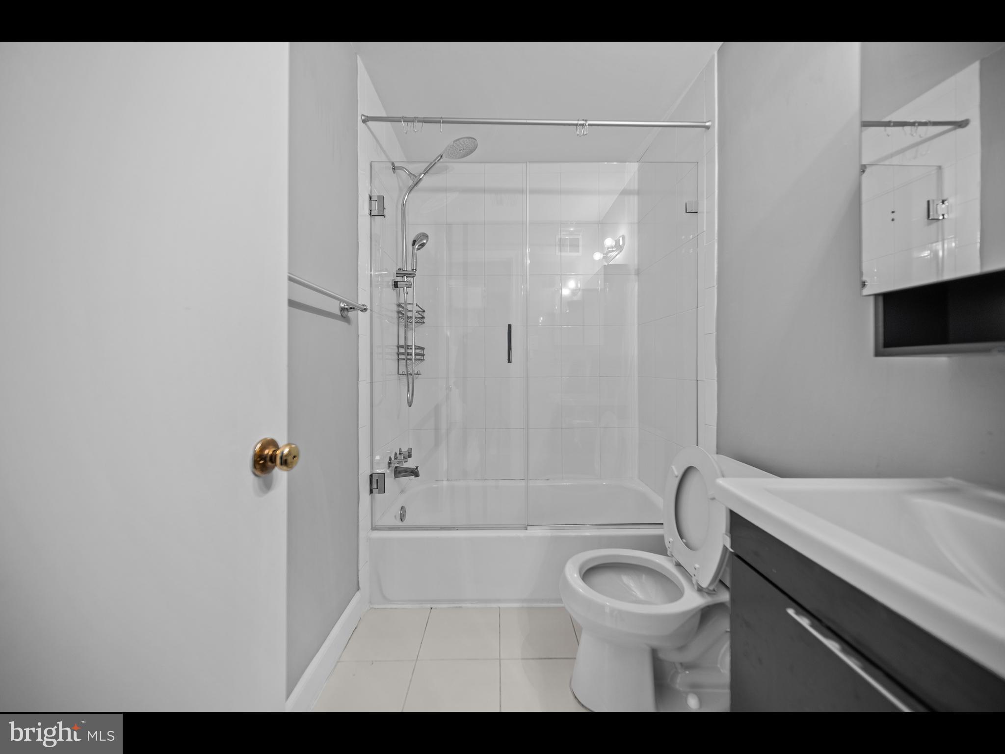 1609 Dunterry Place McLean, VA 22101 - Photo 32 of 36 a bathroom with a granite countertop bathtub shower sink vanity and toilet