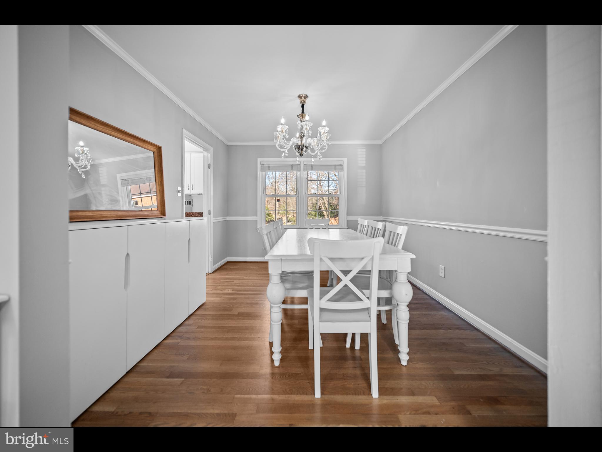 1609 Dunterry Place McLean, VA 22101 - Photo 7 of 36 a view of a dining room with furniture a chandelier and wooden floor